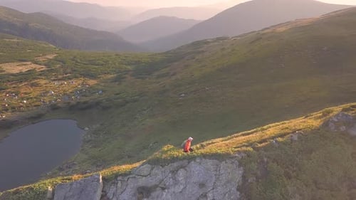 Tourist Hiker with a Backpack Walking on Mountain Path in Carpathian Mountains