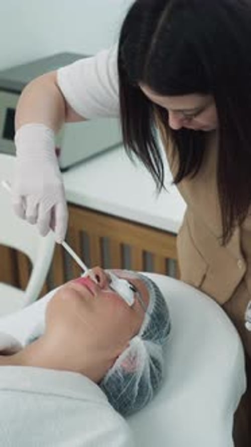 Woman receiving facial mask in a spa