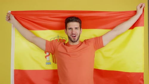 Smiling Man Holding Spanish Flag