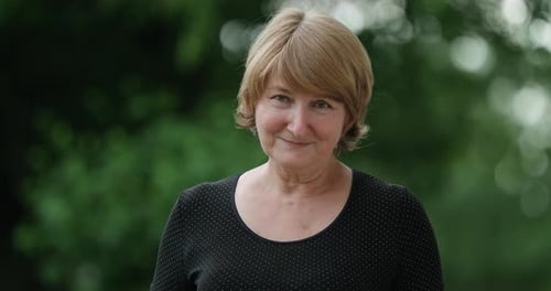 Happy Mature Middle Aged Single Woman Looking at Camera Posing at City for Video Portrait Smiling