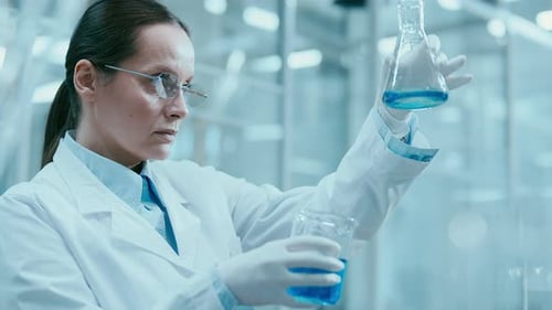 Focused Scientist Mixes Chemicals in Lab Close Up