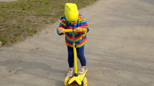 The Child is Riding a Scooter