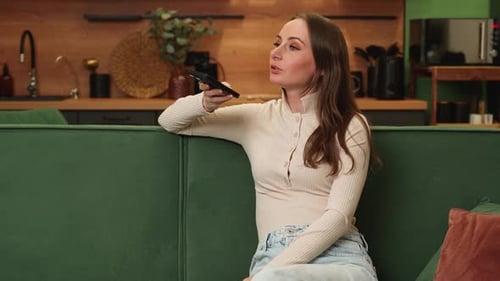 Woman Using Smartphone Voice Assistant on Couch