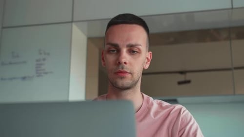 Young adult working on computer at home