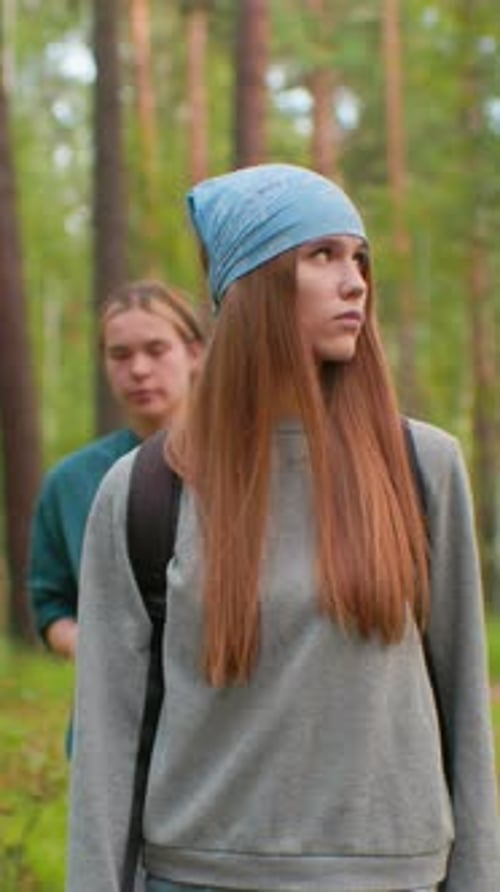 Hikers Walking Along Serene Forest Trail with Thoughtful Gaze