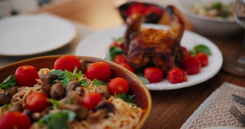 Festive Dinner Table with Pasta and Roast Chicken