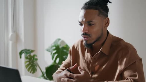 Young Man Attending a Virtual Meeting Indoors