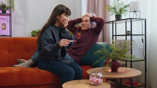 Excited Couple Embraces After Positive Pregnancy Test