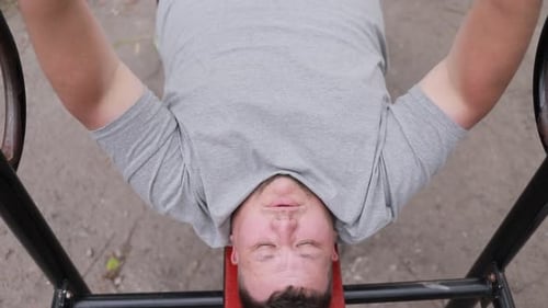 Man Doing Bench Press in Outdoor Park Gym