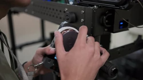 Focus Puller Hands at Work Spins the Focus Wheel Close Up