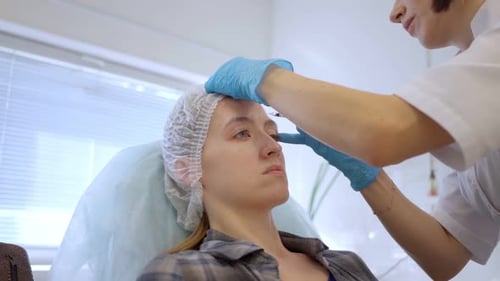 Woman Receives Forehead Injection in Clinic