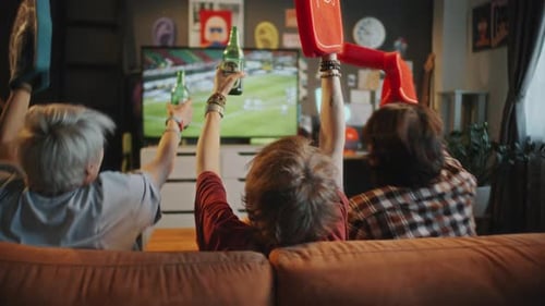 Friends Cheer at Home While Watching Soccer Game