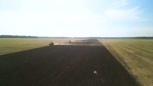 Tractors plowing the field in Ukraine