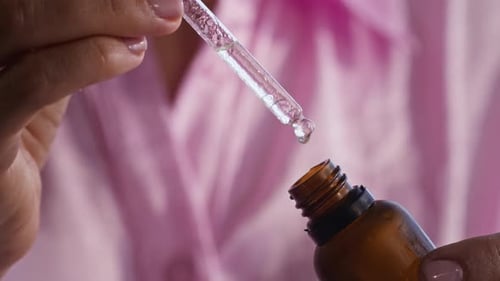 Dropper Dispenses Clear Liquid from Bottle