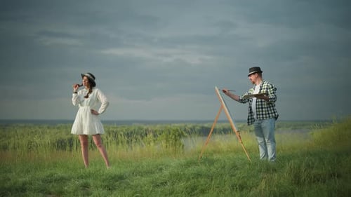 Artist Painting Woman in White Dress By Scenic Lakeside Field