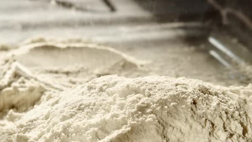 Close up of wheat flour scattered onto pile in the process of baking bread
