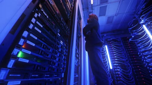 Man analysing servers in a data center