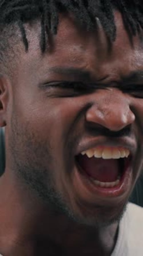 Man close up yelling with intensity, emotion