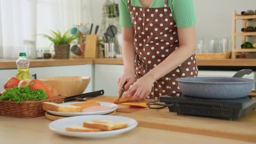 Close up of woman cooking healthy food in kitchen in the morning at home.