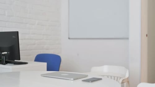 Man Opens Laptop and Types in Modern Office