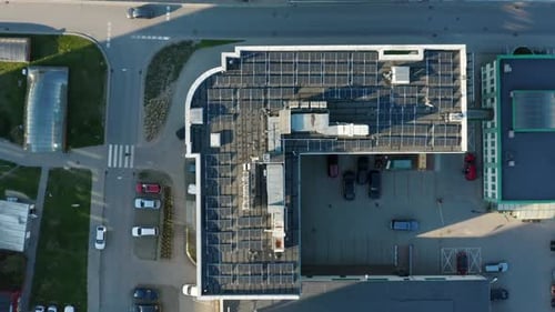 Top View of a System Blue Solar Photovoltaic Panels Roof of an Office Building