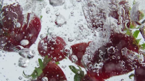 Ripe Strawberry Falling Water in Super Slow Motion Close Up