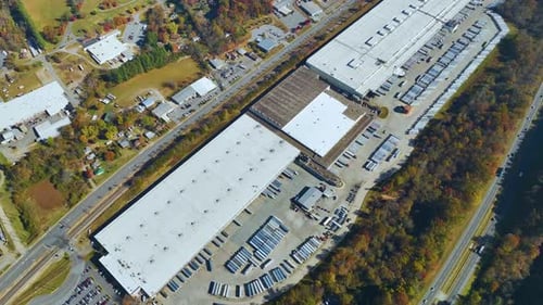 Aerial View of Large Commercial Loading Bay with Many Delivery Trucks Unloading and Uploading Retail
