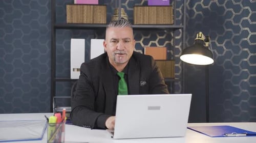 Man Working in Modern Office with Laptop
