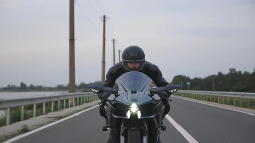 Front View to Biker Riding on Modern Sport Motorbike at Countryside Way Young Motorcyclist Racing