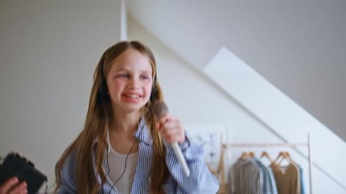 Cheerful Child Dancing and Singing with Brush