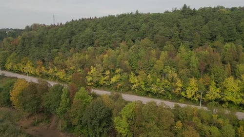 Drone view over green valley and winding roads