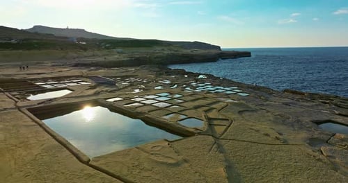 Aerial View of Xwejni Salt Pans Expansive Salt Pans Alongside a Historic Structure Natural Beauty