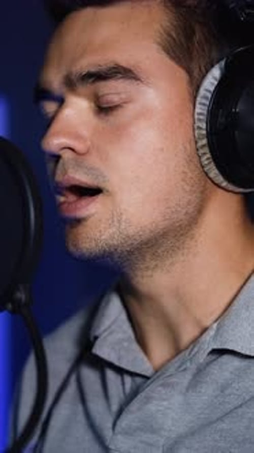 Singer recording a song in the studio.