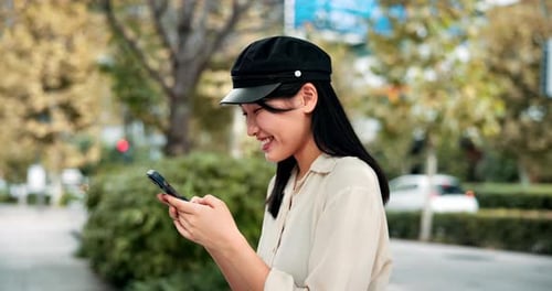 Woman, typing and laughing with phone in city for funny text message, morning commute