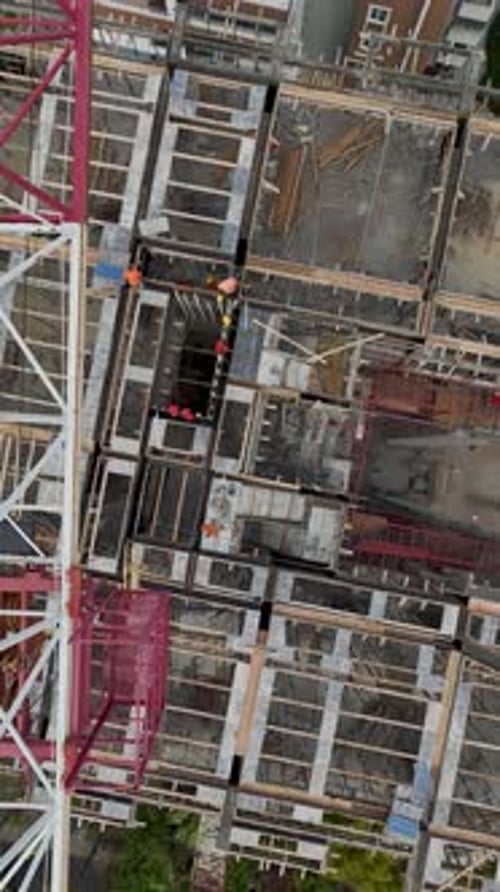 Vertical Video of Construction Crew Fitting Wall Segments