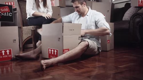 Couple Unpacking Boxes in a New Home