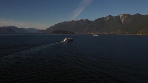 Beautiful view of two ferries sailing on the Howe sound during a winter afternoon, British