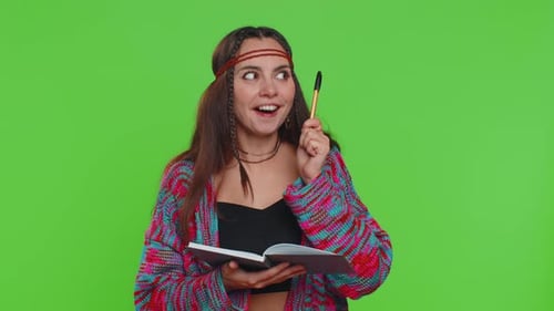 Young Adult Woman Writing in Notebook, Green Screen