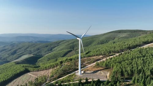 Wind power park in a forest in Portugal. Drone footage.
