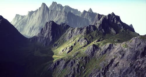 Majestic Mountain Range with Rugged Peaks and Lush Valleys During Daylight