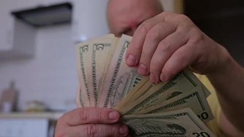 Man Holding United States Dollar Currency Indoors