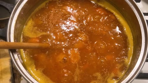 Fruit Preserves Simmering in Pot Being Stirred