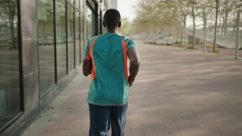 Young Man Running in the City Training Sports