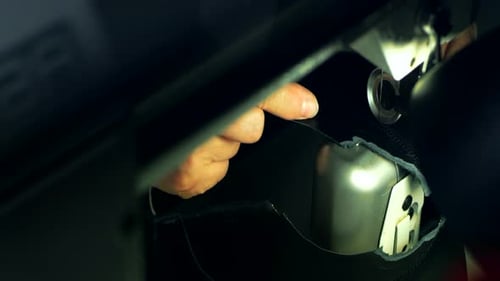 Craftsman hands stitching black leather workpiece in a leather textile workshop