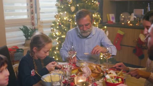 Family Eating Christmas Dinner Together at Home