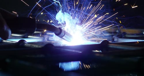 Intense Blue Sparks Flying During Metal Welding