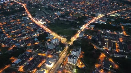 A city at night with a street that is lit up. Aerial Batu Pahat town in night