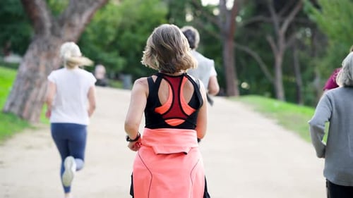 Group of Senior People Running in a Park Together