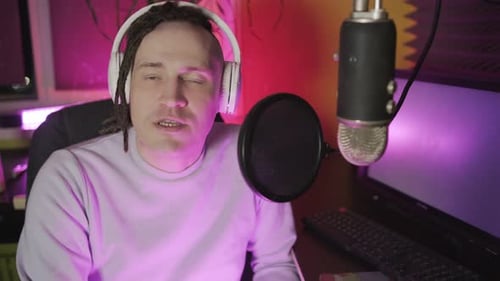 Man Broadcasting with Microphone and Headphones