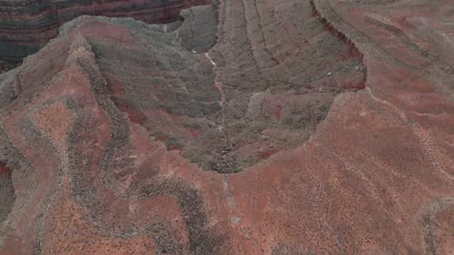 Drone down angle tilt up fly to reveal Goosneck state park canyon in Utah